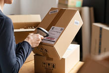 Photo of Person Scanning Packages