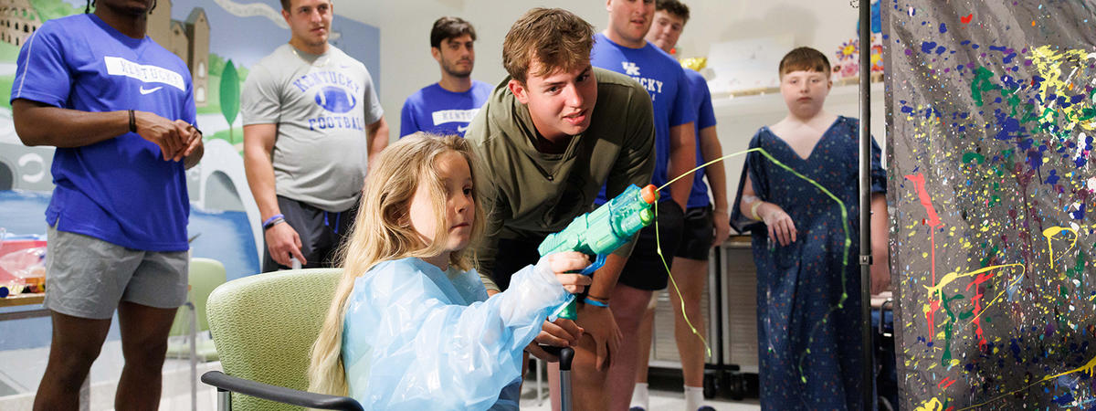 image of josh kattus and patient playing with paint