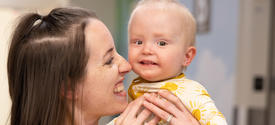 Image of Addi being held by her mother Hannah