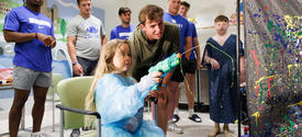 image of josh kattus and patient playing with paint