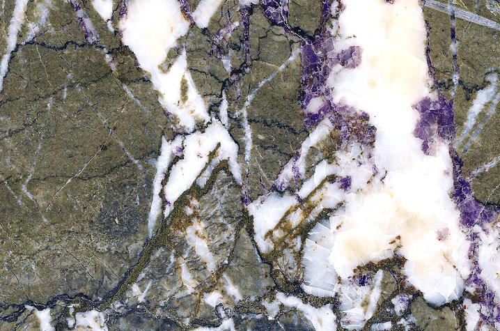 Detail of a core provided by Patrick Gooding, showing fluorite (purple), sphalerite (brown), calcite (white), and limestone (gray).