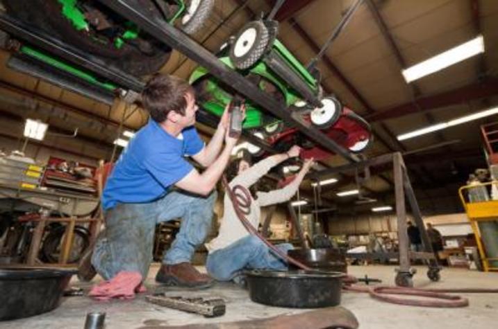 UK students at work at a previous lawn mower clinic