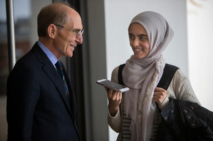 photo of Capilouto and Hadeel Abdallah holding her cellphone