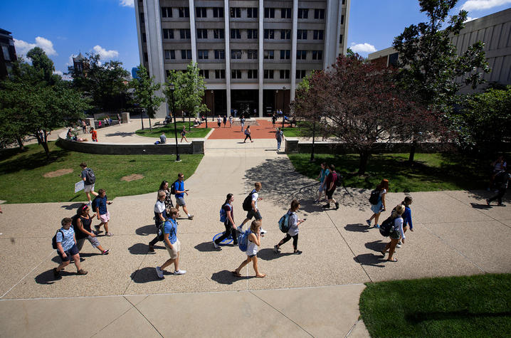 students are walking across campus