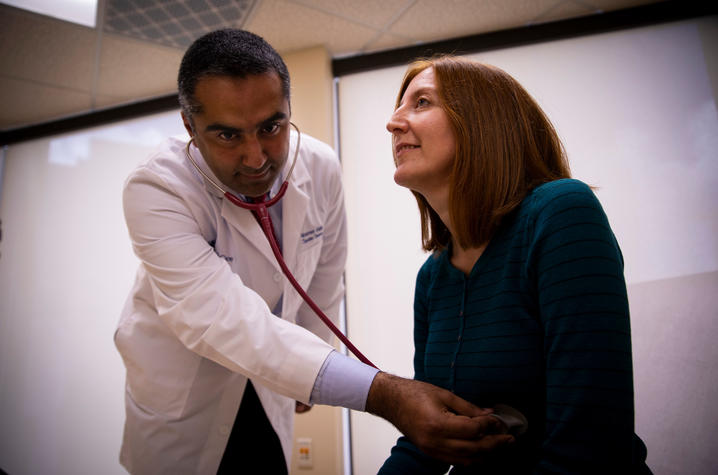 Dr. Moamen Gabr examines patient Jackie Denault
