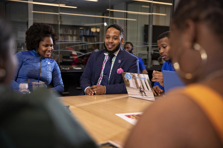 photo of Jason Brooks and students at table in MLK Center