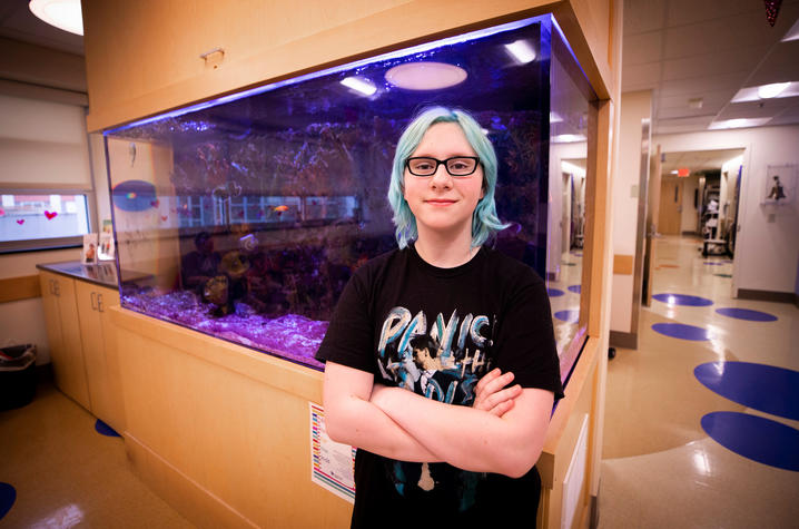 Photo of Bethany Stephens in front of fish tank in DanceBlue clinic