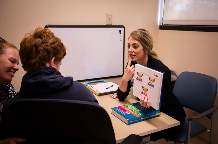 Speech-language pathologist Corie Sexton works with Gray McClanahan | Photo: Pete Comparoni