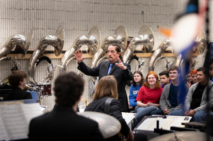 photo of Miles Osland leading UK Jazz Ensemble in concert at Scott County High School's bandroom