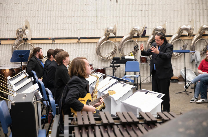 photo of Miles Osland leading UK Jazz Ensemble in concert at Scott County High School's bandroom