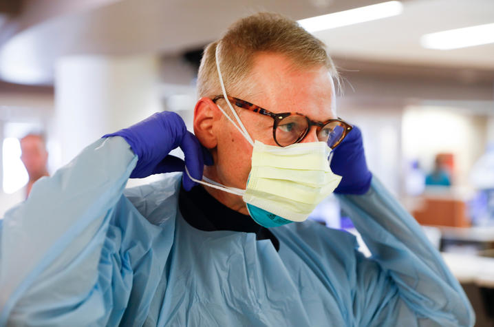 Photo of doctor putting on mask