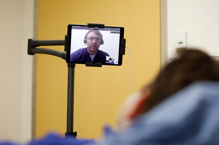 Photo of health care provider doing telemedicine via iPad