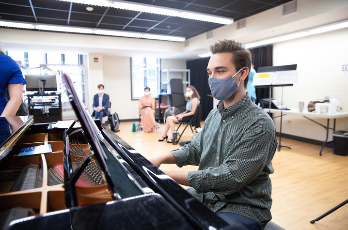 photo of masked pianist playing in Arnold class