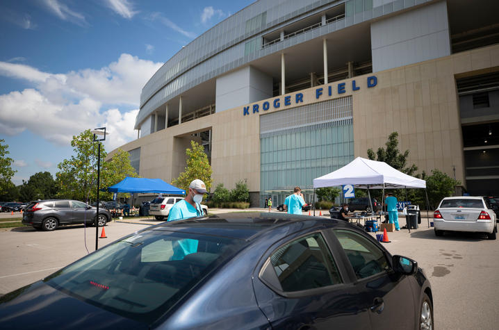 photo of covid testing at Kroger Field in August - cars driving through testing area