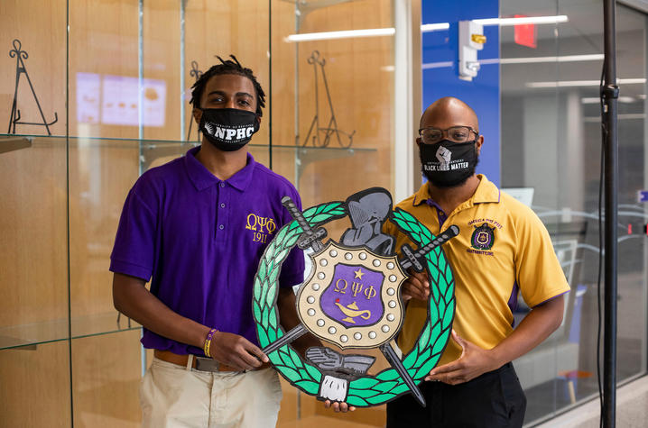 Members of Omega Psi Phi Fraternity, Inc. display their crest.