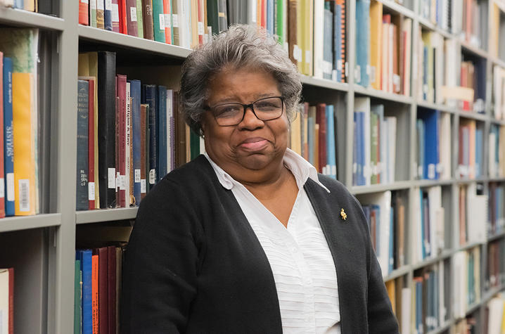 Sharyn Mitchell pictured standing between stacks at Berea College Library