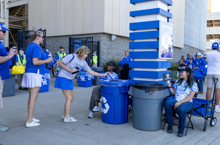 Big Blue Recycling Crew members helping fans at Kroger Field to dispose of their waste. Photo by Bree Walton