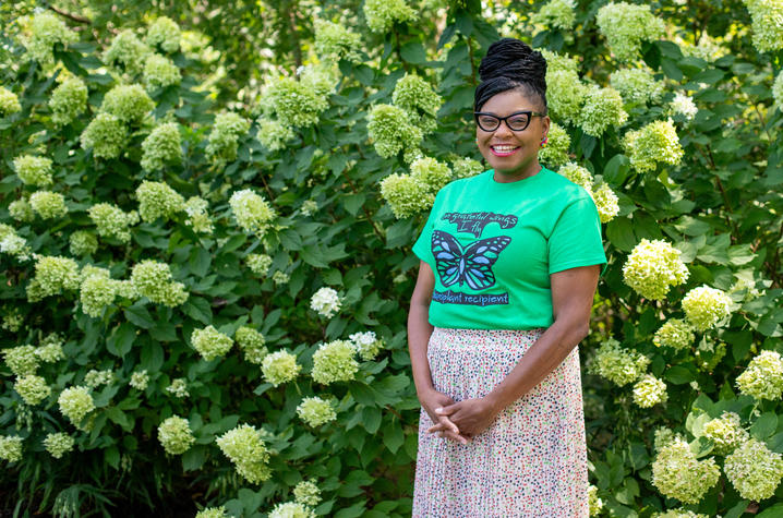 Image of Ashley Holt standing in front of hydrangeas 