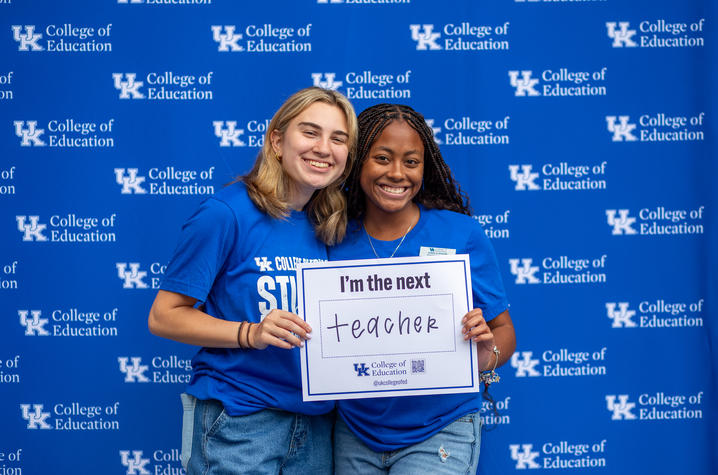 Two students holding a "I'm the next teacher" sign. 
