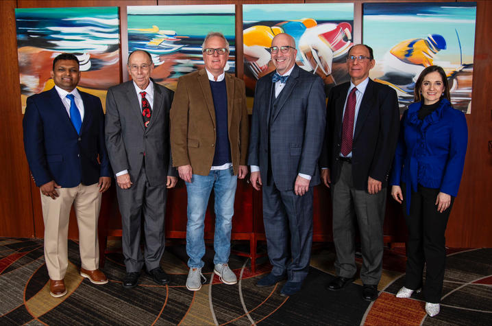 photo of 2026 Great Teacher Award winners Six people stand side by side indoors, posing for a group photo in front of colorful artwork.