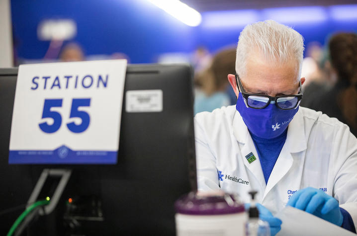 White-haired man at vaccine station