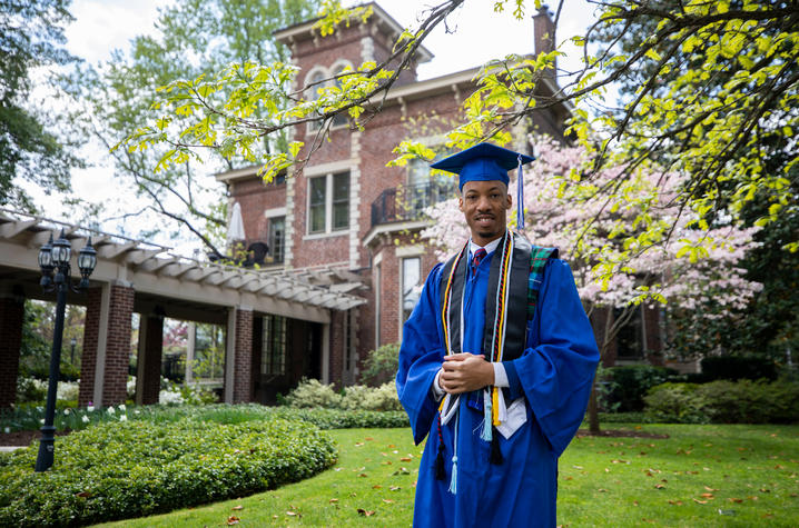 photo of Montre'ale Jones in cap and gown in front of Maxwell Place