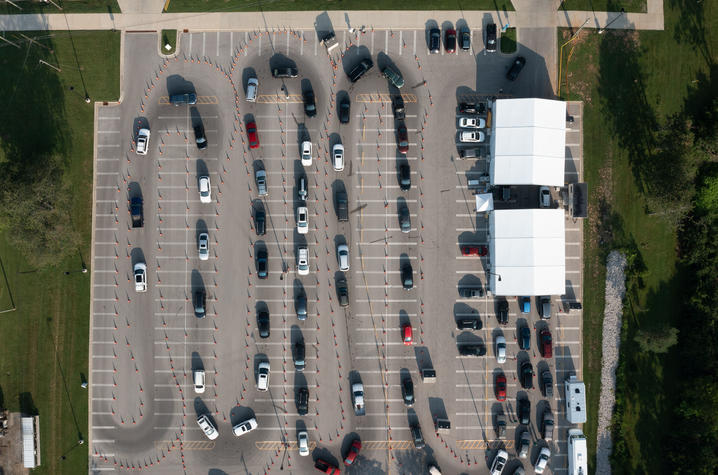 Aerial photos of a long line of cars in a parking lot