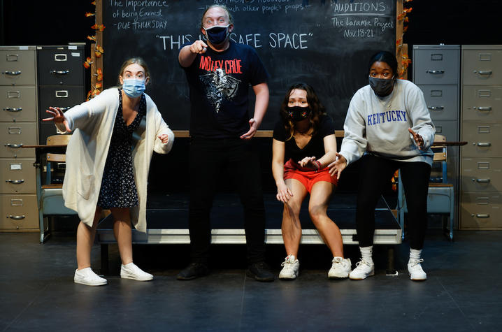 photo of cast members rehearsing UK Theatre's "The Thanksgiving Play" standing in front of chalkboard