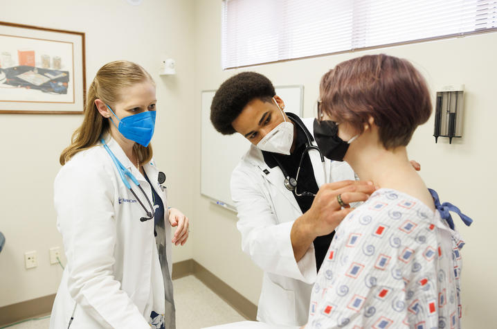 UK College of Medicine students examining a patient.