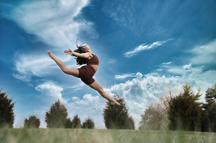 photo of dancer jumping in field