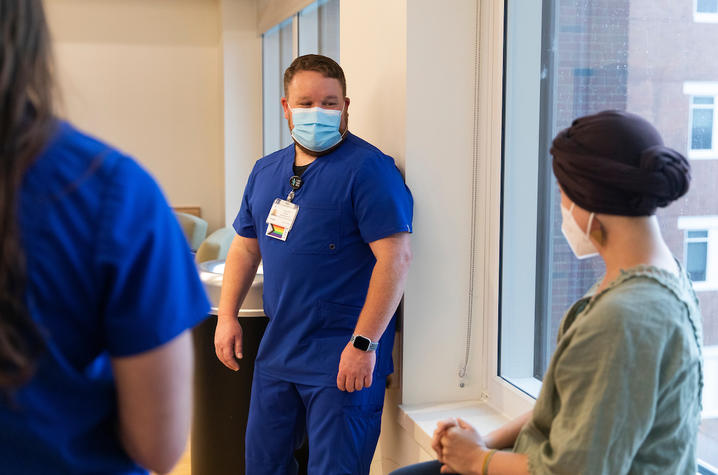 Katelyn McNamara, UK Markey Cancer Center patient, talks with nurse Travis Gort.