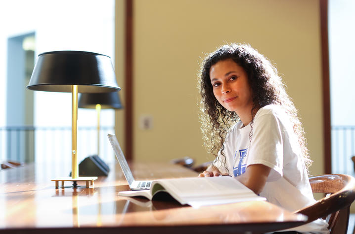 This is a photo of a student in the William T. Young Library. 