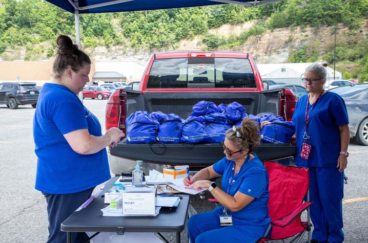 UK HealthCare's mobile care unit in Hazard, Ky. is offering basic wound care and vaccinations. Team members are also handing out backpacks with supplies for flood survivors. Photo by Hilary Brown.