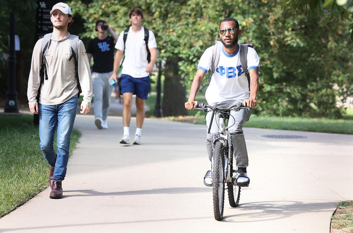 Someone riding a bike on campus. 