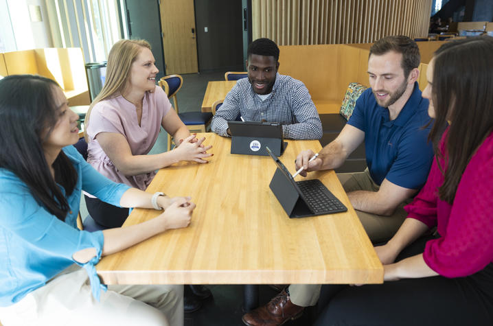 This is a photo of students working and talking together in a building on UK's campus.