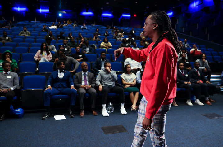 Photo of Keynote speaker George Conscious Lee  speaking at the 2023 Men of Color Symposium.