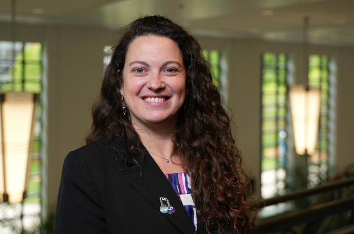 luciana shaddox standing and smiling for a portrait in the student center.