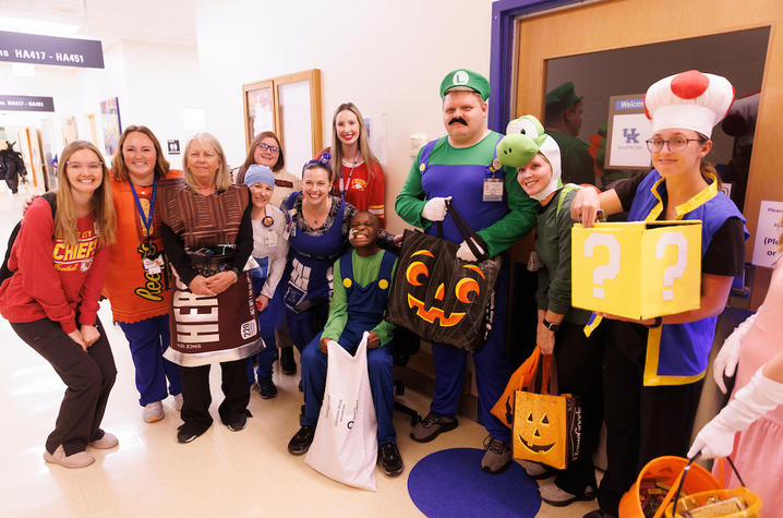 image of costumed staff members posing with patient