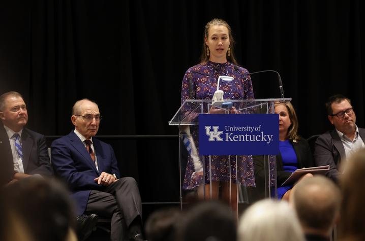 Photo of Mallory Martinez. Young woman at podium