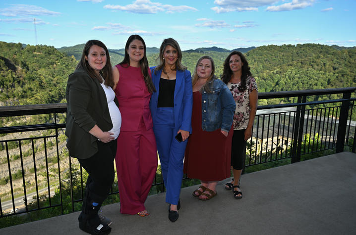 a group of women stand along a railing at the Overlook Events Center in Pikeville, Kentucky