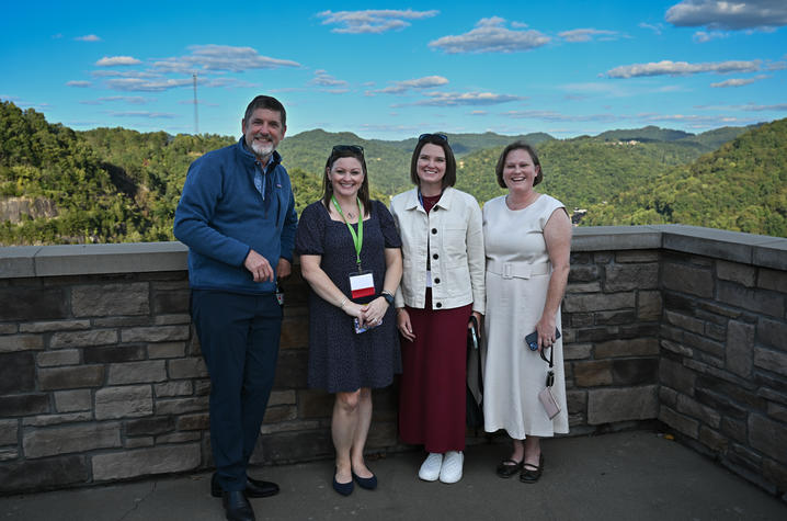 A group of people stand along a rock wall at the Overlook Events Center in Pikeville, Kentucky