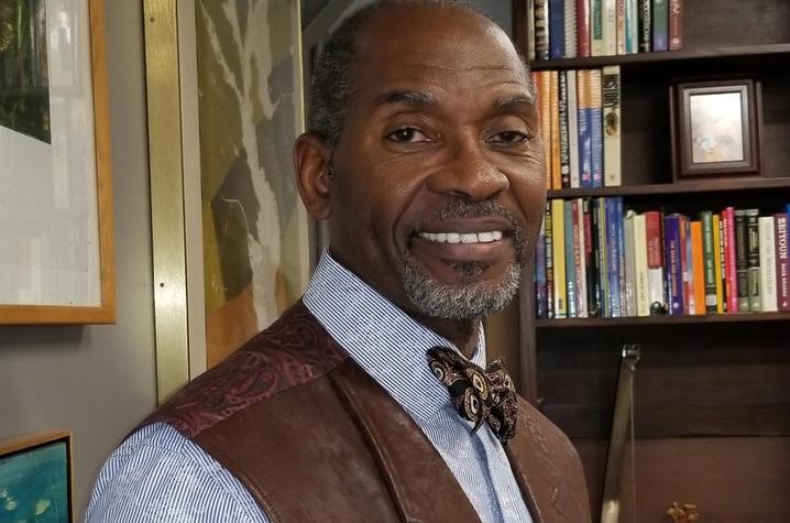 photo of Allan Richards in front of bookcase