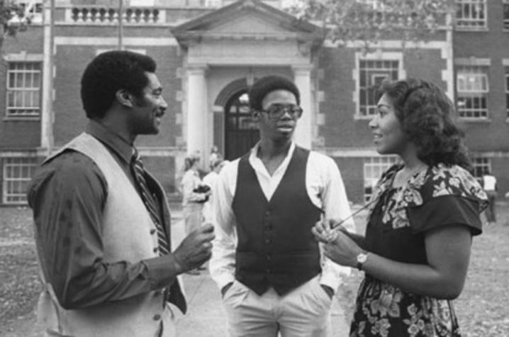 1978 black and white photo of college recruiter Alvin C. Hanley with 2 others on campus