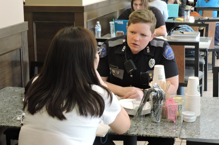 photo of UK Police Officer Amy Boatman talking to a member of the campus community.  