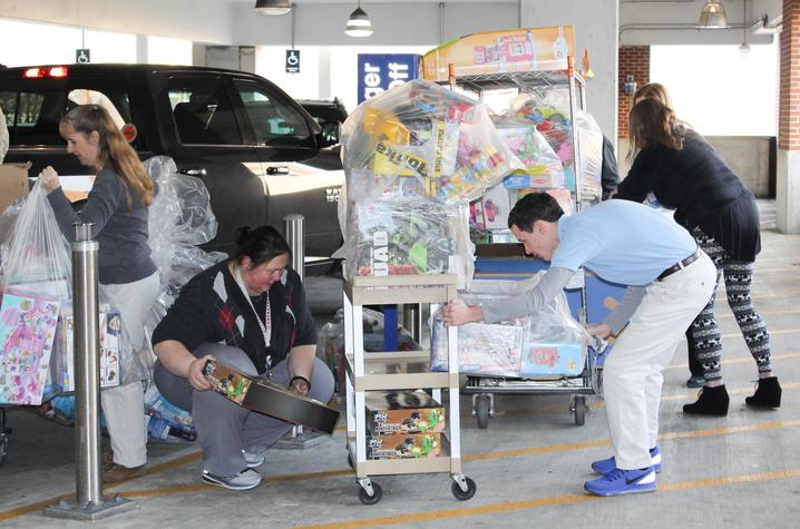 Staff from the Kentucky Children's Hospital collect the donations from the Ard family.