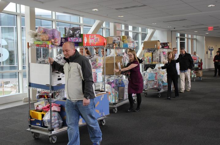 Members of the Ard family and staff from Kentucky Children's Hospital transport the donations collected in Jon's memory.