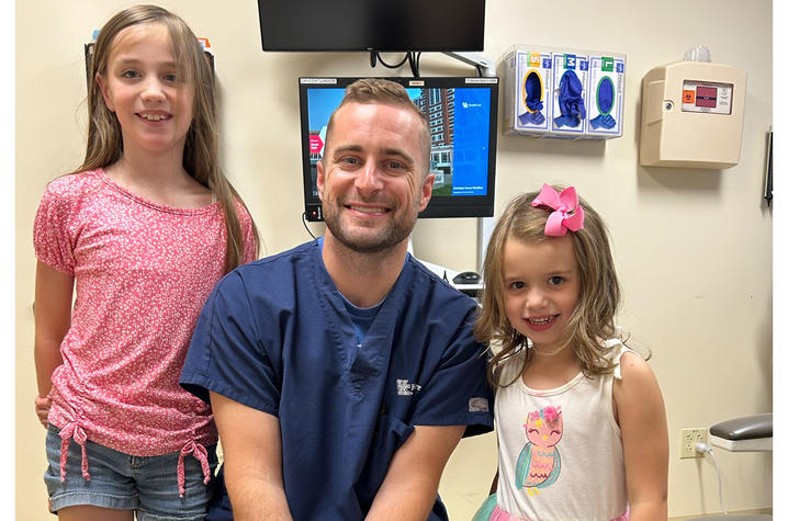 Anna Kerri Cundiff (left) and her little sister Amelia (right) have continued to see Dr. Chris Azbell (center). Photo provided by Cundiff family.