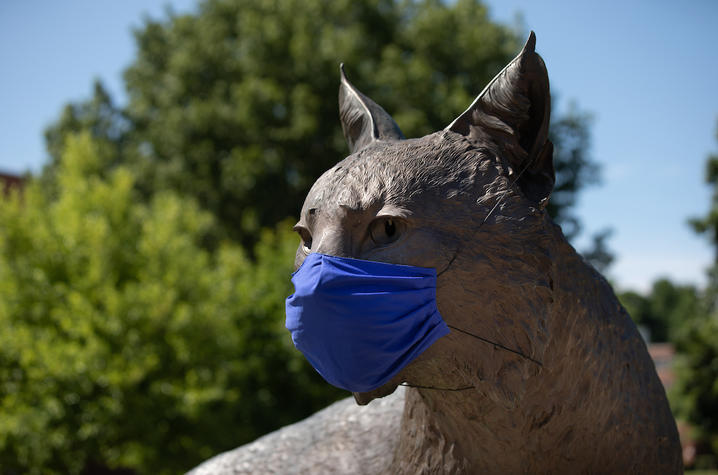 photo of Bowman in Wildcat Alumni Plaza wearing a UK blue mask
