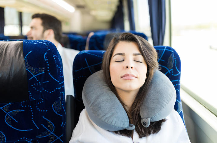 Woman taking a nap on a bus. 