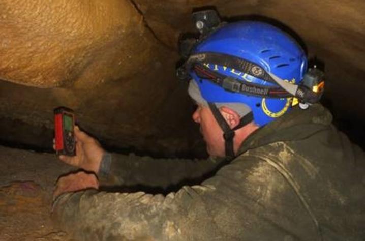 Bruce Isaacs, who discovered Kentucky’s 5,000th cave, explores another underground passage.